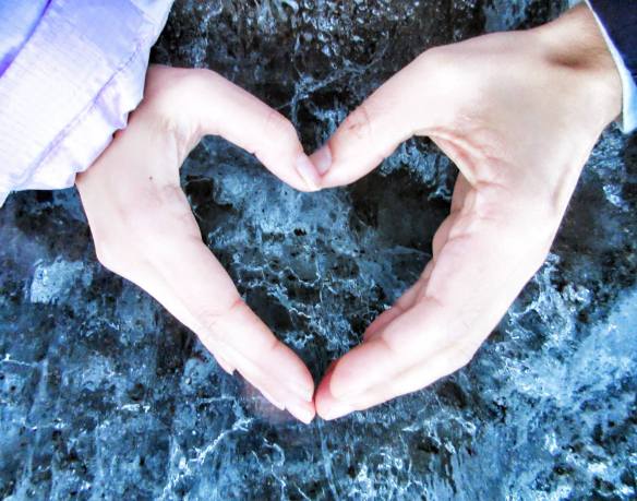 In Love in Iceland - Hands Form a Heart over a Glacier
